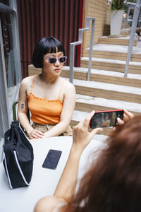 Portrait of young woman using mobile phone