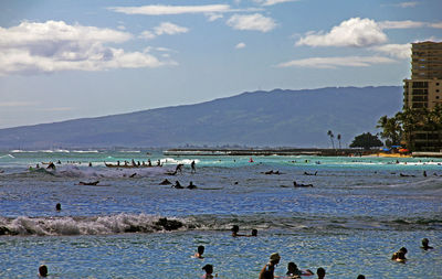 Group of people swimming in sea