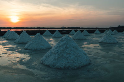 Colorful sunset landscape view of salt farm or salt pan.