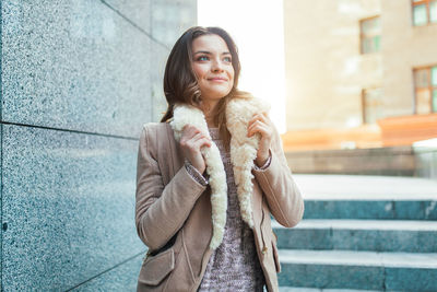 Woman standing in city during winter