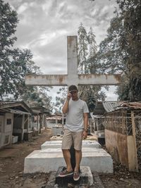 Full length of man standing by built structure against sky