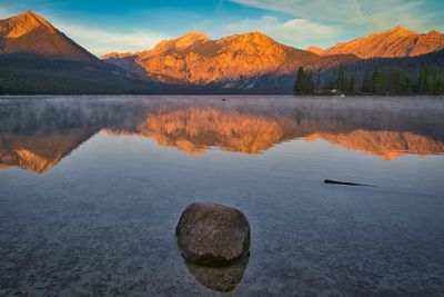 Scenic view of lake and mountains against sky