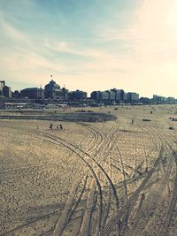 Scenic view of beach against sky in city