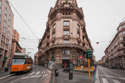 Tramway amidst buildings in city