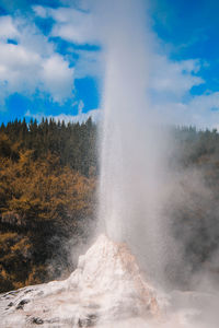 Close-up of water splashing against sky