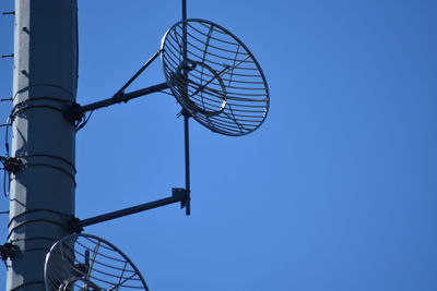 Low angle view of street light against clear blue sky