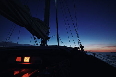 Silhouette of sailboat against sky at sunset