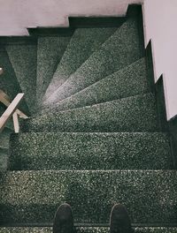 Low section of person standing on staircase of building