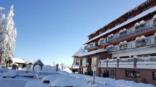 Houses against clear sky during winter