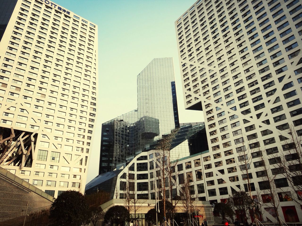 building exterior, architecture, built structure, city, skyscraper, modern, office building, tall - high, tower, low angle view, building, sky, city life, capital cities, cityscape, glass - material, financial district, day, tall, clear sky