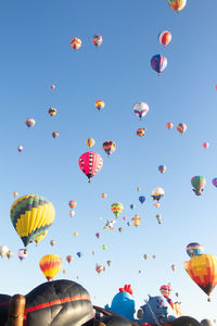 Low angle view of hot air balloons flying in sky