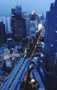 High angle view of illuminated cityscape at dusk