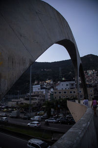 Bridge over city street against clear sky