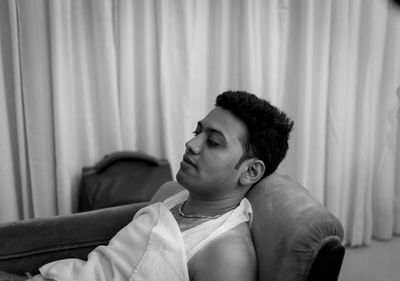 Portrait of young man looking away at home