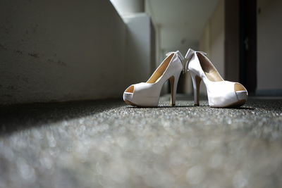 Close-up of white shoes on table