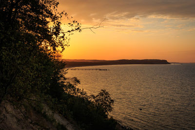 Scenic view of sea against orange sky