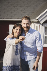 Smiling couple holding house keys