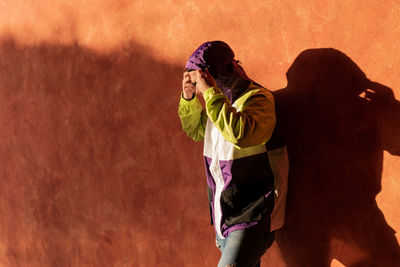 Man standing by wall