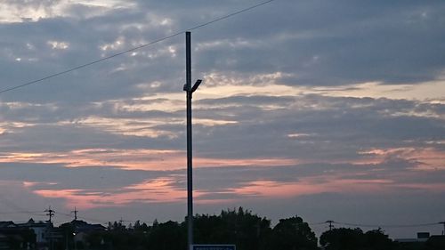 Low angle view of silhouette trees against sky at sunset