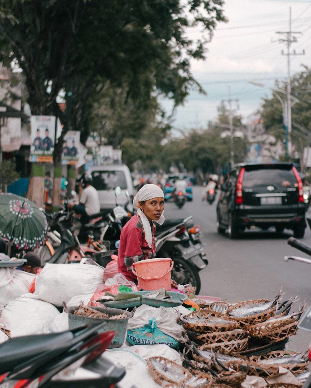 transportation, mode of transportation, city, incidental people, car, real people, motor vehicle, people, day, adult, tree, road, street, hat, women, land vehicle, clothing, lifestyles, men, outdoors