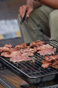 Meat roasting on small barbeque in southern vietnam. bbq.