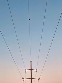 Low angle view of electricity pylon against sky