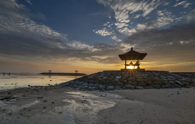 Scenic view of beach against sky during sunset
