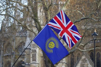 Low angle view of flag against built structure