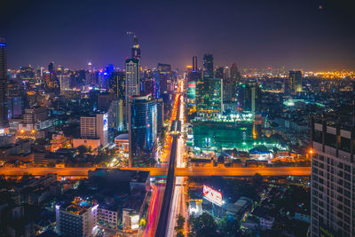 Aerial view of city lit up at night