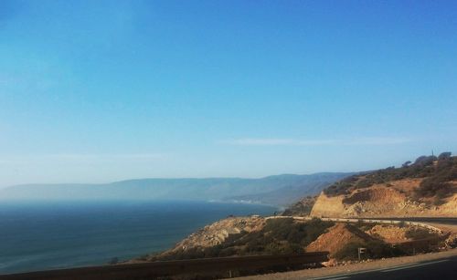 Scenic view of mountains against clear blue sky