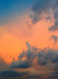 Low angle view of cloudy sky at sunset