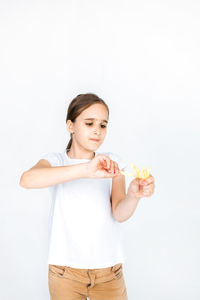 Young woman standing against white background