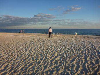 Man on beach against sky