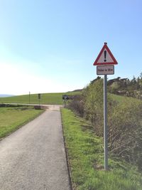 Road sign against clear sky
