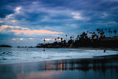 Scenic view of sea against cloudy sky at sunset