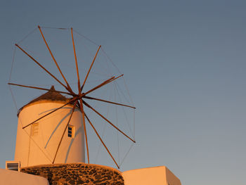 Low angle view of traditional windmill against clear sky