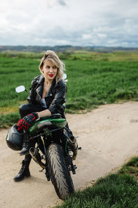 Woman in leather jacket on motorcycle with adventurous spirit. woman in black leather jacket and