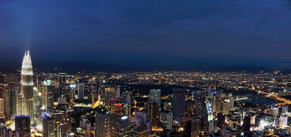 High angle view of city lit up at night