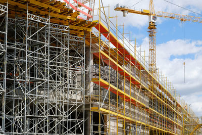 Low angle view of construction site against sky