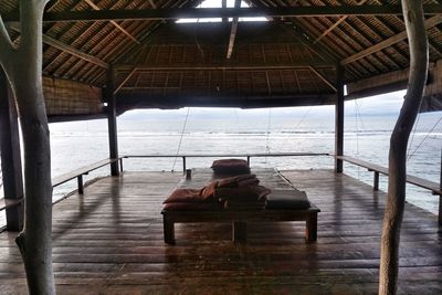 Rear view of woman sitting on seat in sea