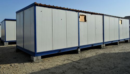 Metallic structure on field against clear sky