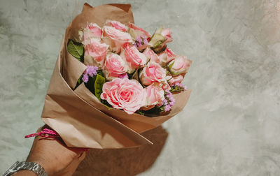 Midsection of woman holding rose bouquet