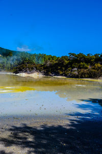 Scenic view of lake against blue sky