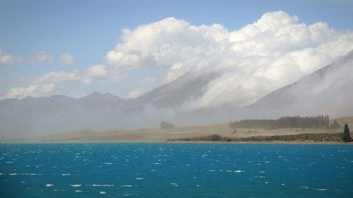 Scenic view of mountains against cloudy sky