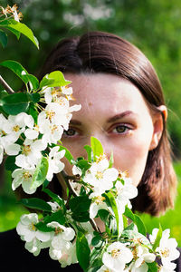 Close-up of woman with pink flowers