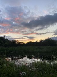 Scenic view of field against sky during sunset