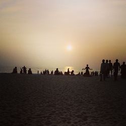 People on beach at sunset