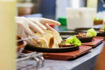 Close-up of person preparing food on cutting board