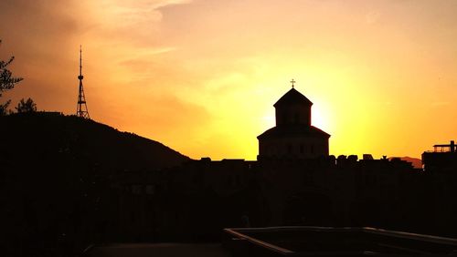 Silhouette building against sky during sunset