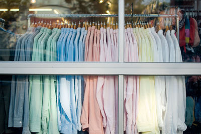 Shirts hanging from hanger in retail store